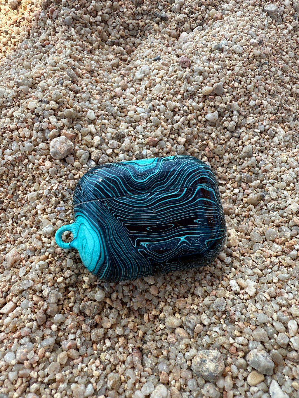 Blue stone with a unique pattern on a sandy surface