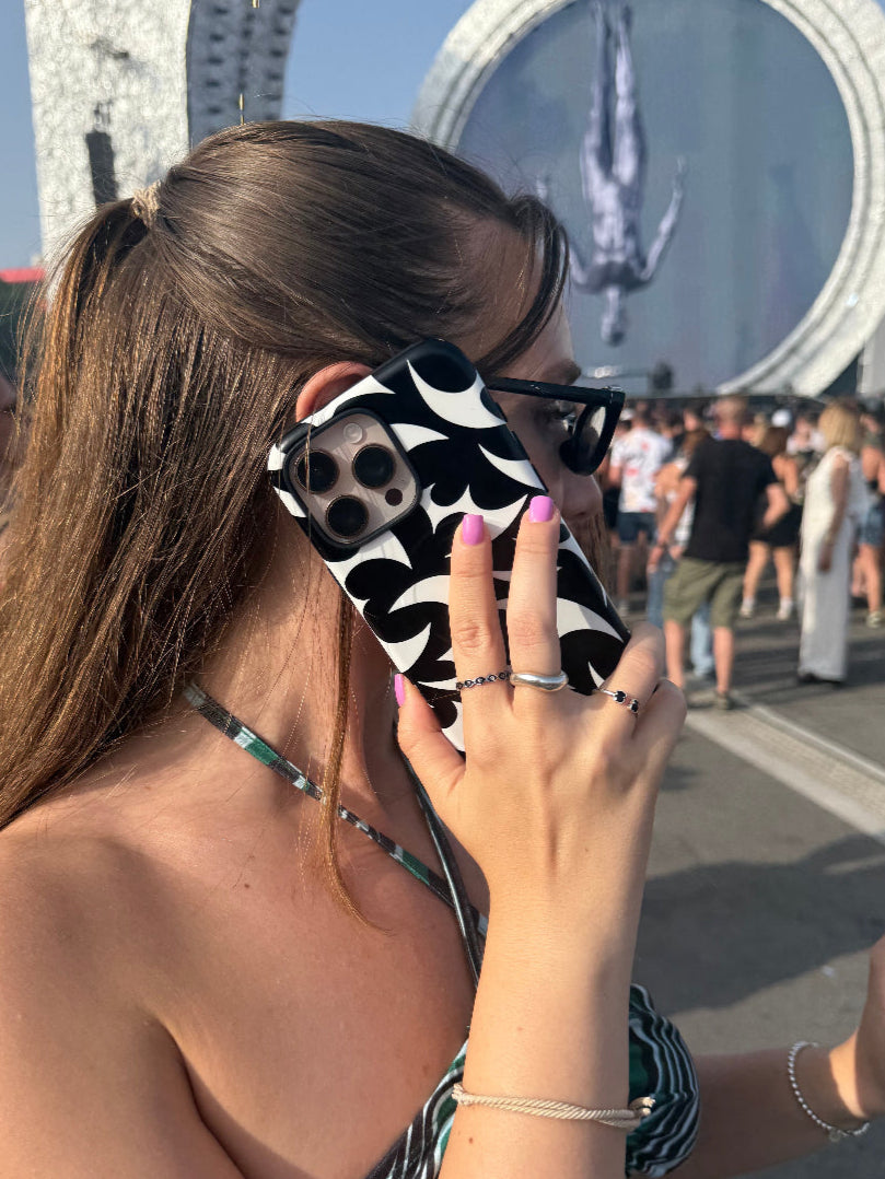 A Girl in festival outfit holding an iPhone Case | Case Temple