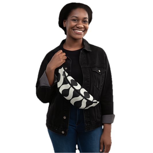 Woman holding a black and white patterned bag against a white background