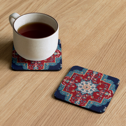 Cup of tea on a decorative coaster with another coaster next to it on a wooden surface