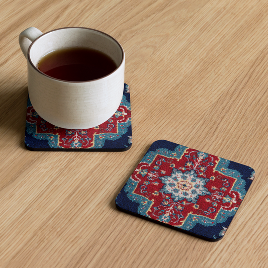 Cup of tea on a decorative coaster with another coaster next to it on a wooden surface